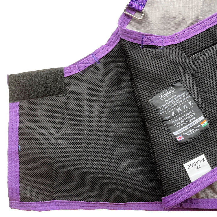 A close-up of the AniMac Sheep Coat | Waterproof in black and purple, featuring breathable mesh, a velcro strap, and a label with care instructions, material details, and flags from the UK and India.