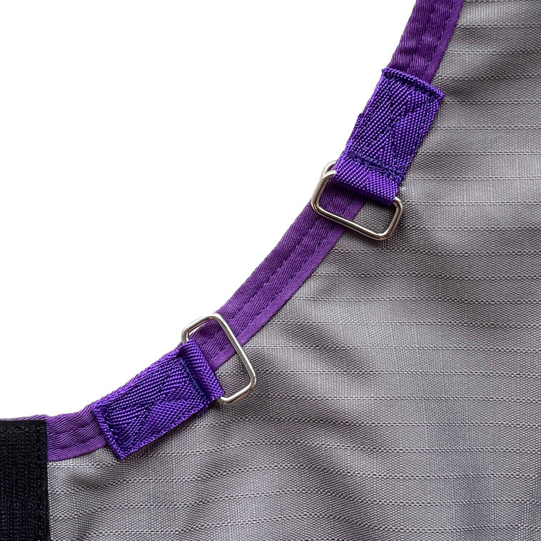 Close-up of the Super Calf Jacket | Lightweight Waterproof in gray with a purple edge, featuring two purple straps with silver rectangular rings, designed to keep newborn calves warm.