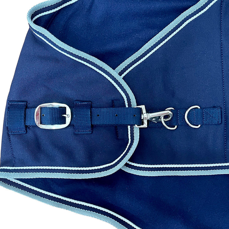 Close-up of the AniMac Drying Sheep Coat | Wicking/Cooler in navy blue with light blue trim, featuring moisture-wicking fabric, a metal buckle, snap hook, and adjustable metal rings for comfort.