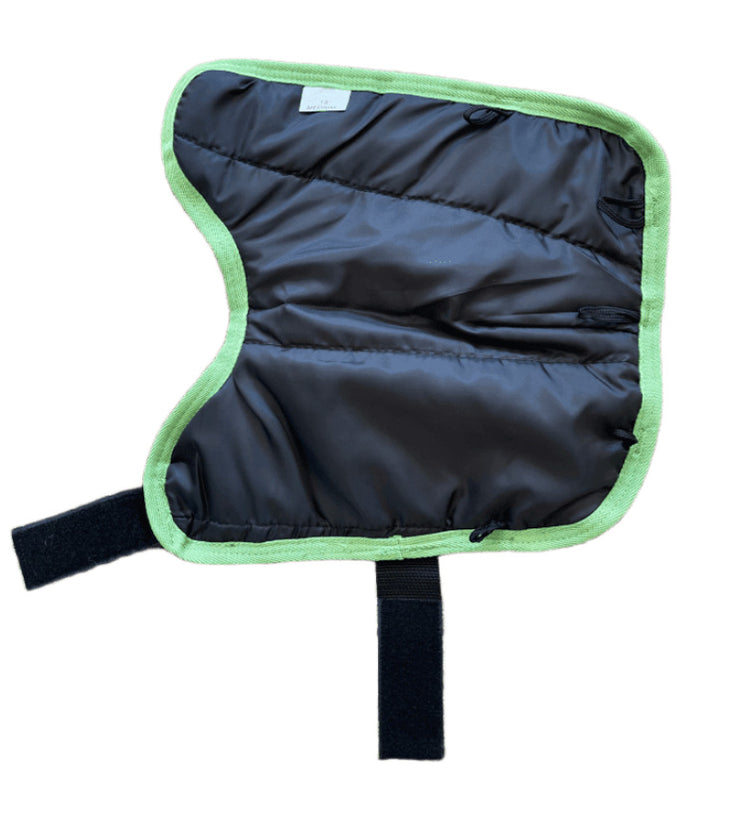The AniMac Lamb Coat | Waterproof is a black, padded, quilted fabric coat with light green trim and two black Velcro straps at the bottom and side, shown on a white background.