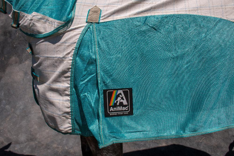 Close-up of the AniMac Allrounder Fly Rug Combo in turquoise and beige with a black logo patch featuring a rainbow stripe, draped over a horse’s back. Ideal for those seeking high-quality clearance horse rugs at great prices.